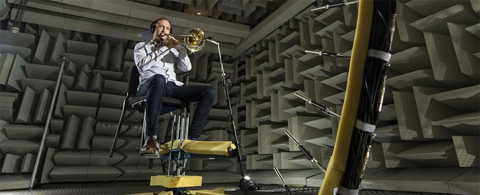 Student playing trombone in the BYU anechoic chamber